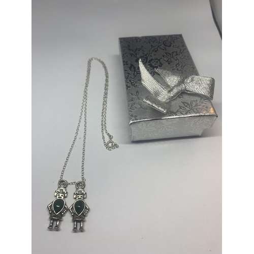 528 - A SILVER NECKLACE WITH TWO SILVER AND GREEN STONE ROBOT PENDANTS WITH A PRESENTATION BOX
