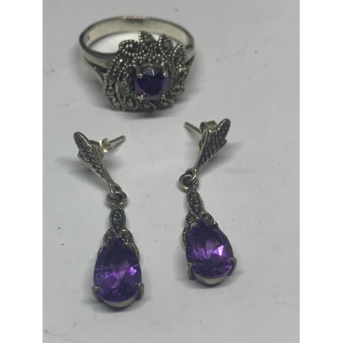 546 - A SILVER MARCASITE AND PURPLE STONE RING WITH MATCHING EARRINGS IN A PRESENTATION BOX