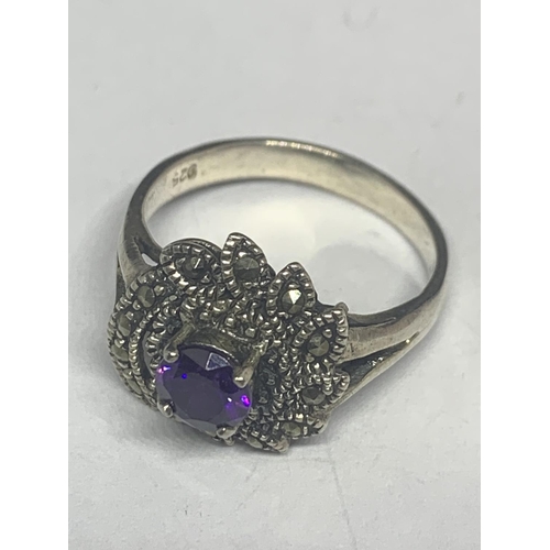 546 - A SILVER MARCASITE AND PURPLE STONE RING WITH MATCHING EARRINGS IN A PRESENTATION BOX