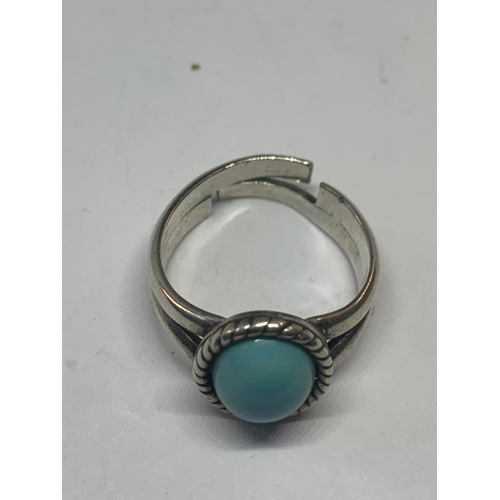 577 - A SILVER RING WITH AN OVAL BLUE NAVAJO STYLE STONE