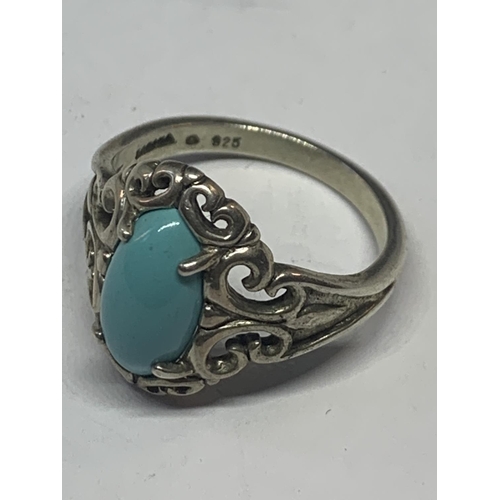 578 - AN ORNATE SILVER RING WITH A BLUE NAVAJO STYLE STONE IN A PRESENTATION BOX