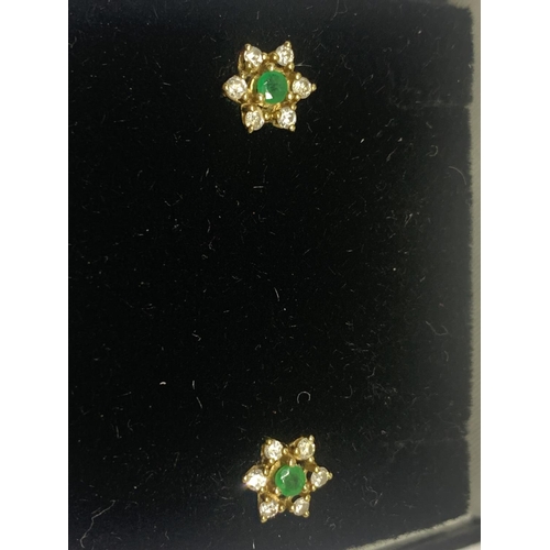 590 - A PAIR OF 18 CARAT GOLD, EMERALD AND POSSIBLY DIAMOND EARRINGS IN A FLOWER DESIGN WITH A PRESENTATIO... 