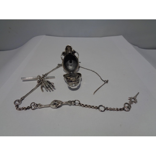 610 - A HEAVY SILVER ALBERT CHAIN WITH LARGE SKULL FOB AND BONE, HAND ETC DESIGN