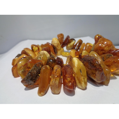 628 - A BUTTERSCOTCH AMBER NECKLACE GROSS WEIGHT 149 GRAMS LENGTH 56CM