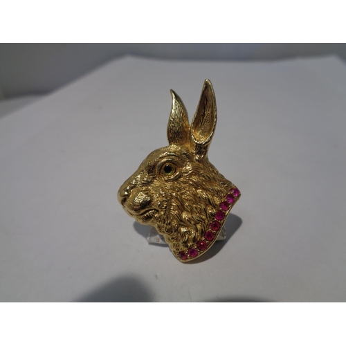 648 - A SILVER GILT PENDANT IN THE FORM OF A HARE WITH A PINK STONE COLLAR