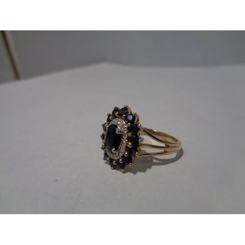 652 - A 9 CARAT GOLD CLUSTER RING WITH A CENTRE SAPPHIRE AND SURROUNDING DIAMONDS AND SAPPHIRES SIZE 0