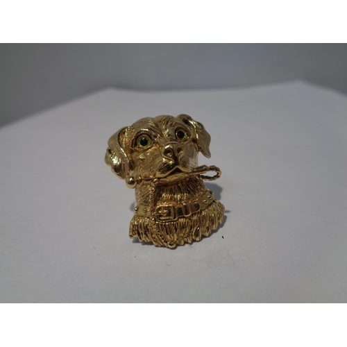 653 - A SILVER GILT PENDANT IN THE FORM OF A DOG WITH GLASS EYES