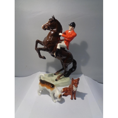 720 - A BESWICK REARING BAY HORSE HUNTSMAN WITH A FOX AND A HOUND