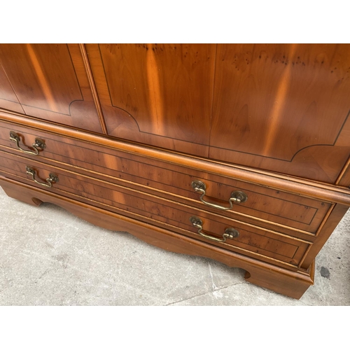 2443 - A YEW WOOD TV CABINET AND A NEST OF TABLES