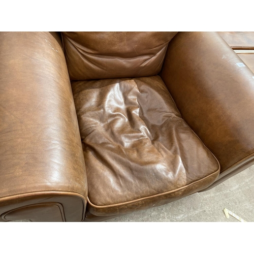 2444 - A MODERN LEATHER EASY CHAIR ON BUN FEET AND FOOTSTOOL WITH HINGED LID