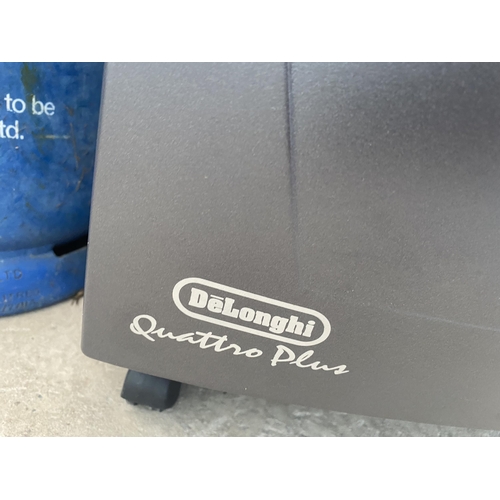 A DELONGHI GAS HEATER WITH A CALOR GAS BOTTLE