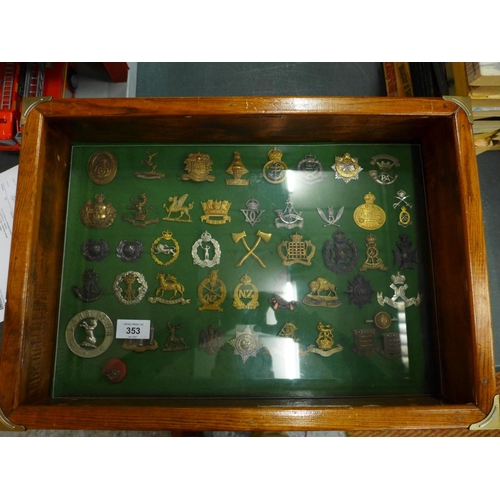 353 - A GLAZED DISPLAY CASE CONTAINING FORTY SIX BRITISH ARMY CAP BADGES, 33 CM X 48 CM