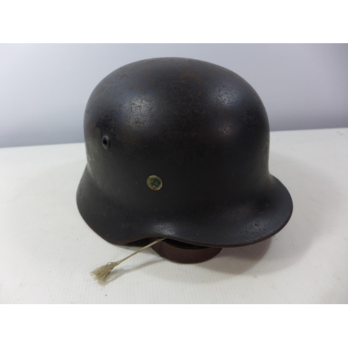 398 - A NAZI GERMANY BLACK PAINTED HELMET WITH BLACK, WHITE AND RED DECAL, LEATHER LINING