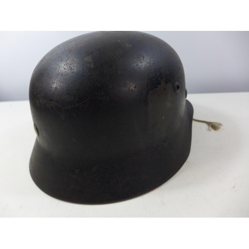 398 - A NAZI GERMANY BLACK PAINTED HELMET WITH BLACK, WHITE AND RED DECAL, LEATHER LINING