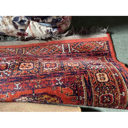 2967 - A RED PATTERNED RUG AND A BEIGE RUG