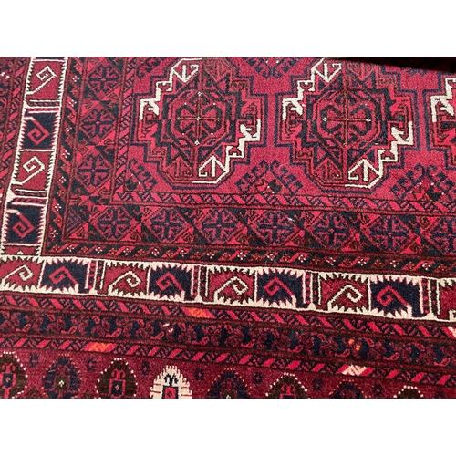 2974 - A RED PATTERNED RUG