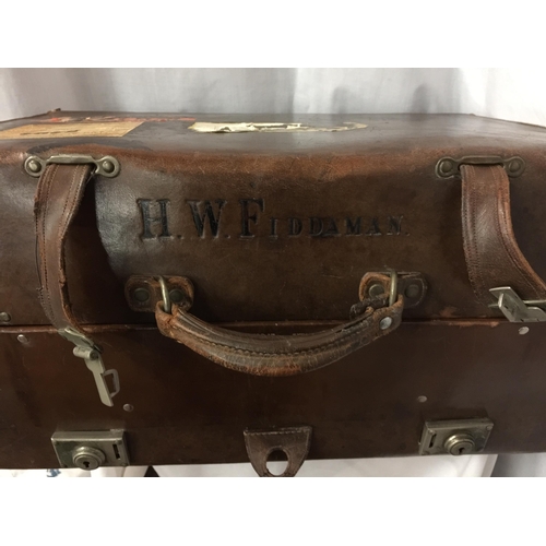 6 - A THE MARTIN WITH EVERLASTING SPRINGS LEATHER SUITCASE STAMPED H W FIDDAMAN WITH LABELS TO INCLUDE P... 