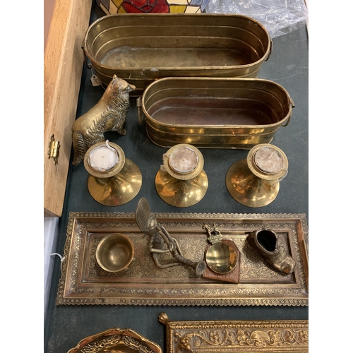 174 - A COLLECTION OF BRASSWARE TO INCLUDE AN INKWELL, CANDLESTICKS, PLANTERS, FIGURES, ETC