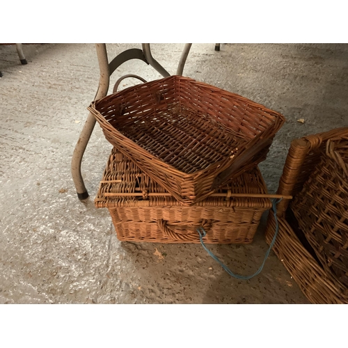 185 - FIVE WICKER BASKETS, A PICNIC BASKET AND A SMALL LEATHER SUITCASE