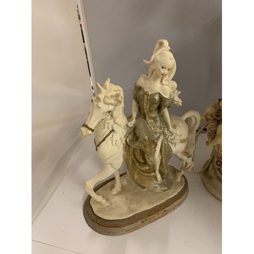 195 - A RESIN MODEL OF A LADY ON A HORSE AND AN ORNATE TABLE LAMP DECORATED WITH CHERUBS AND HORSES