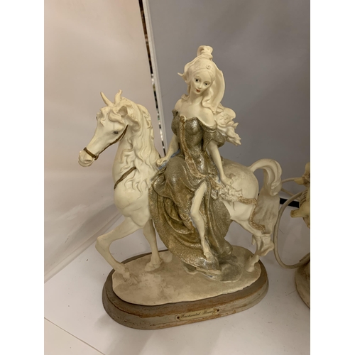 195 - A RESIN MODEL OF A LADY ON A HORSE AND AN ORNATE TABLE LAMP DECORATED WITH CHERUBS AND HORSES