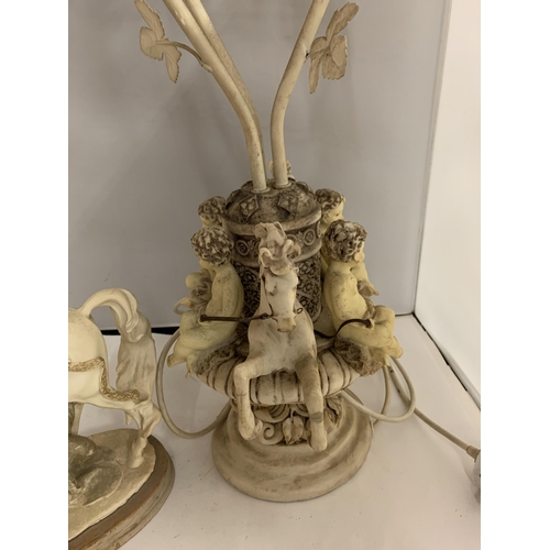 195 - A RESIN MODEL OF A LADY ON A HORSE AND AN ORNATE TABLE LAMP DECORATED WITH CHERUBS AND HORSES