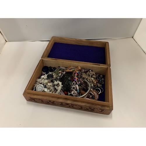 110 - A DECORATIVE WOODEN BOX OF COSTUME JEWELLERY