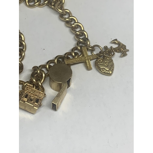 501 - A 9 CARAT GOLD CHARM BRACELET WITH NINE CHARMS TO INCLUDE A 1900 VICTORIA GOLD SOVEREIGN IN A MOUNT ... 