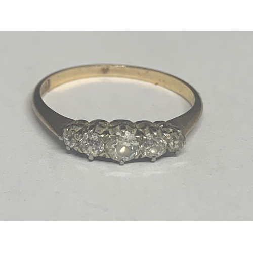 502 - A MARKED 18 CT GOLD RING WITH FIVE GRADUATED IN LINE DIAMONDS SIZE P/Q GROSS WEIGHT 1.9 GRAMS