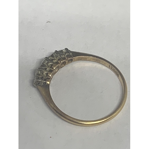 502 - A MARKED 18 CT GOLD RING WITH FIVE GRADUATED IN LINE DIAMONDS SIZE P/Q GROSS WEIGHT 1.9 GRAMS