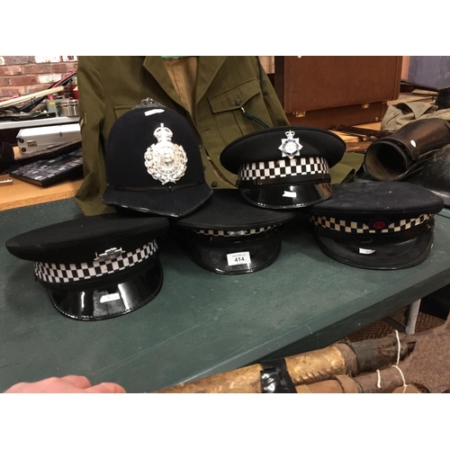 414 - FIVE ASSORTED BRITISH POLICE HATS, TO INCLUDE GUERNSEY, LEEDS CITY, SCOTLAND ETC