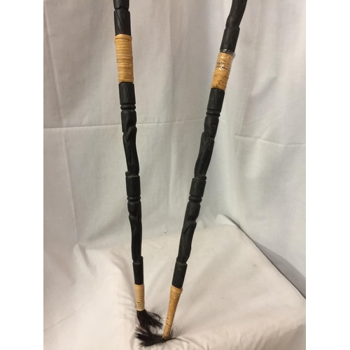 430 - TWO CARVED WOODEN SPEARS WITH DETACHABLE COVERS