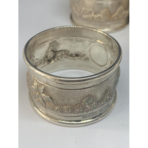 527 - FIVE NAPKIN RINGS MARKED STERLING SILVER (FOUR MATCHING WITH A DESIGN AND ENGRAVED A AND ONE PLAIN) ... 