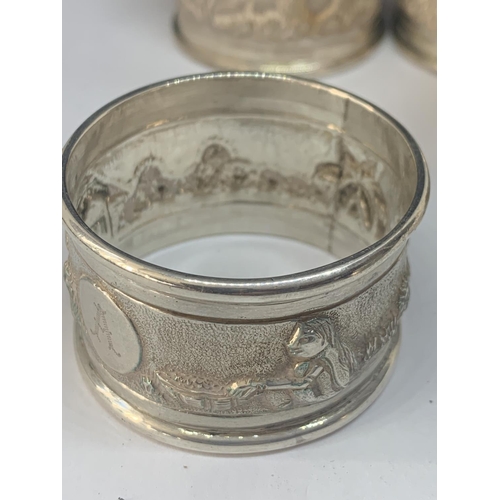 527 - FIVE NAPKIN RINGS MARKED STERLING SILVER (FOUR MATCHING WITH A DESIGN AND ENGRAVED A AND ONE PLAIN) ... 