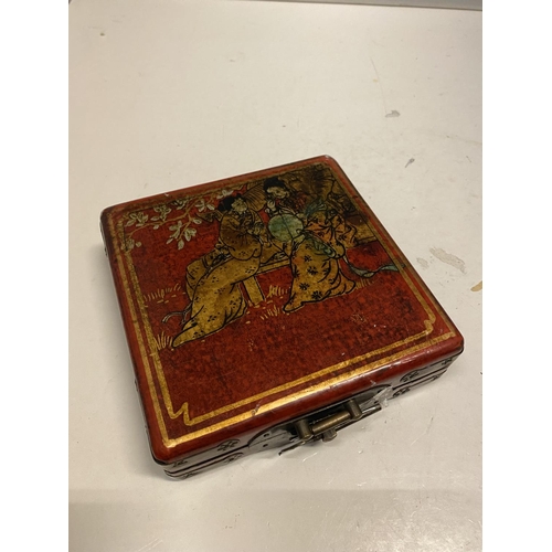 78 - AN ORIENTAL DECORATED TRINKET BOX WITH A PICTURE OF GEISHA GIRLS AGAINST A RED BACKGROUND SIZE 14CM ... 