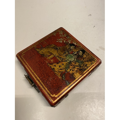 78 - AN ORIENTAL DECORATED TRINKET BOX WITH A PICTURE OF GEISHA GIRLS AGAINST A RED BACKGROUND SIZE 14CM ... 