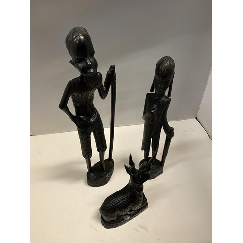 89 - A GROUP OF THREE CARVED EBONY AFRICAN FIGURES TO INCLUDE, TWO MEN AND A DEER