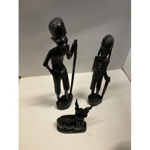 89 - A GROUP OF THREE CARVED EBONY AFRICAN FIGURES TO INCLUDE, TWO MEN AND A DEER