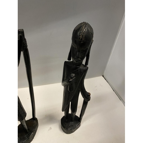 89 - A GROUP OF THREE CARVED EBONY AFRICAN FIGURES TO INCLUDE, TWO MEN AND A DEER