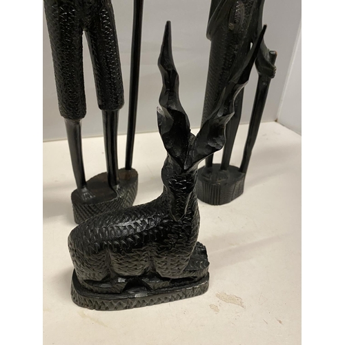 89 - A GROUP OF THREE CARVED EBONY AFRICAN FIGURES TO INCLUDE, TWO MEN AND A DEER