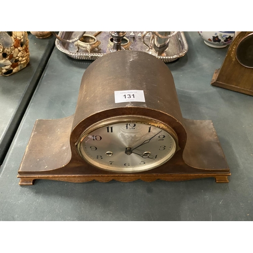 131 - A NAPOLEONS HAT MAHOGANY CASED MANTLE CLOCK- WORKING AT TIME OF CATALOGING