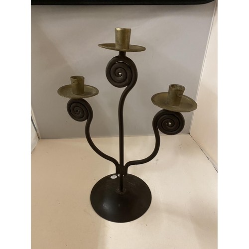 143 - AN ARTS & CRAFTS STYLE METAL CANDLESTICK FOR THREE CANDLES