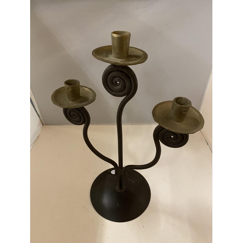 143 - AN ARTS & CRAFTS STYLE METAL CANDLESTICK FOR THREE CANDLES