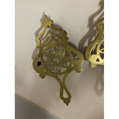 147 - TWO BRASS TRIVETS LENGTH 25CM