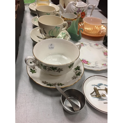 261 - A NUMBER OF CERAMIC MUGS, SOUP DISHES AND A TEAPOT