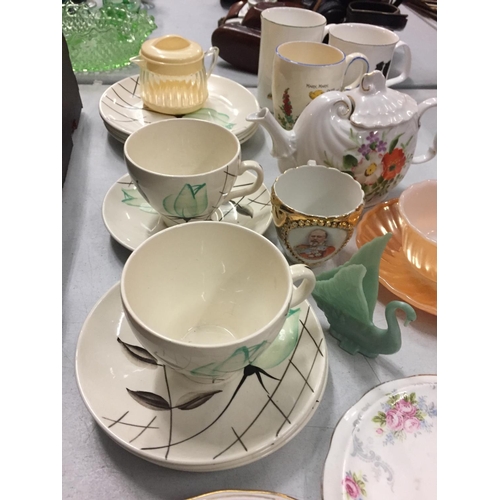 261 - A NUMBER OF CERAMIC MUGS, SOUP DISHES AND A TEAPOT