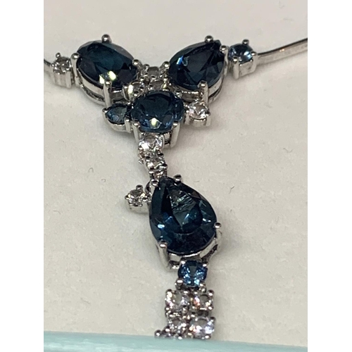 590 - A BOXED MARKED SILVER BLUE STONE NECKLACE WITH BLUE AND CLEAR STONES AND FOUR CLEAR STONE STUD EARRI... 