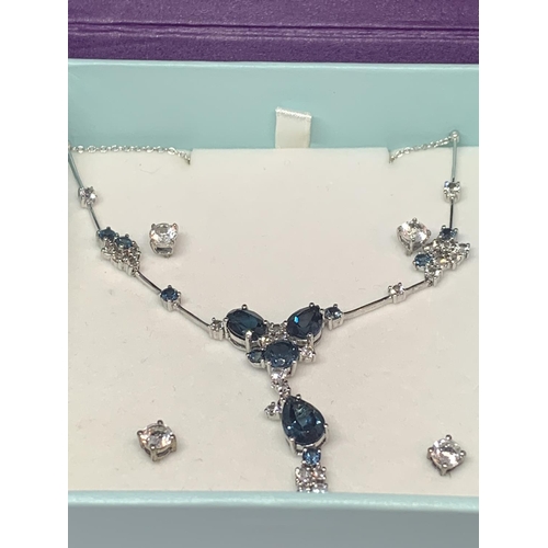 590 - A BOXED MARKED SILVER BLUE STONE NECKLACE WITH BLUE AND CLEAR STONES AND FOUR CLEAR STONE STUD EARRI... 