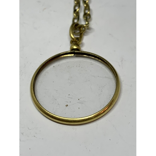 625 - A YELLOW METAL MONOCLE WITH MATCHING CHAIN