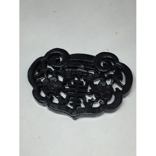 661 - AN ORIENTAL STYLE CARVED PENDANT